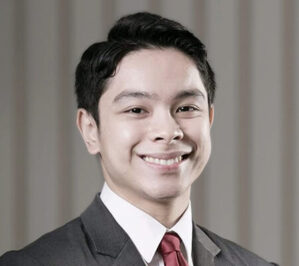 Pineda, Juan Virgilio Nathaniel Mercado (Jv)_final Headshot of a person in a suit and tie, smiling, with a blurred neutral background.